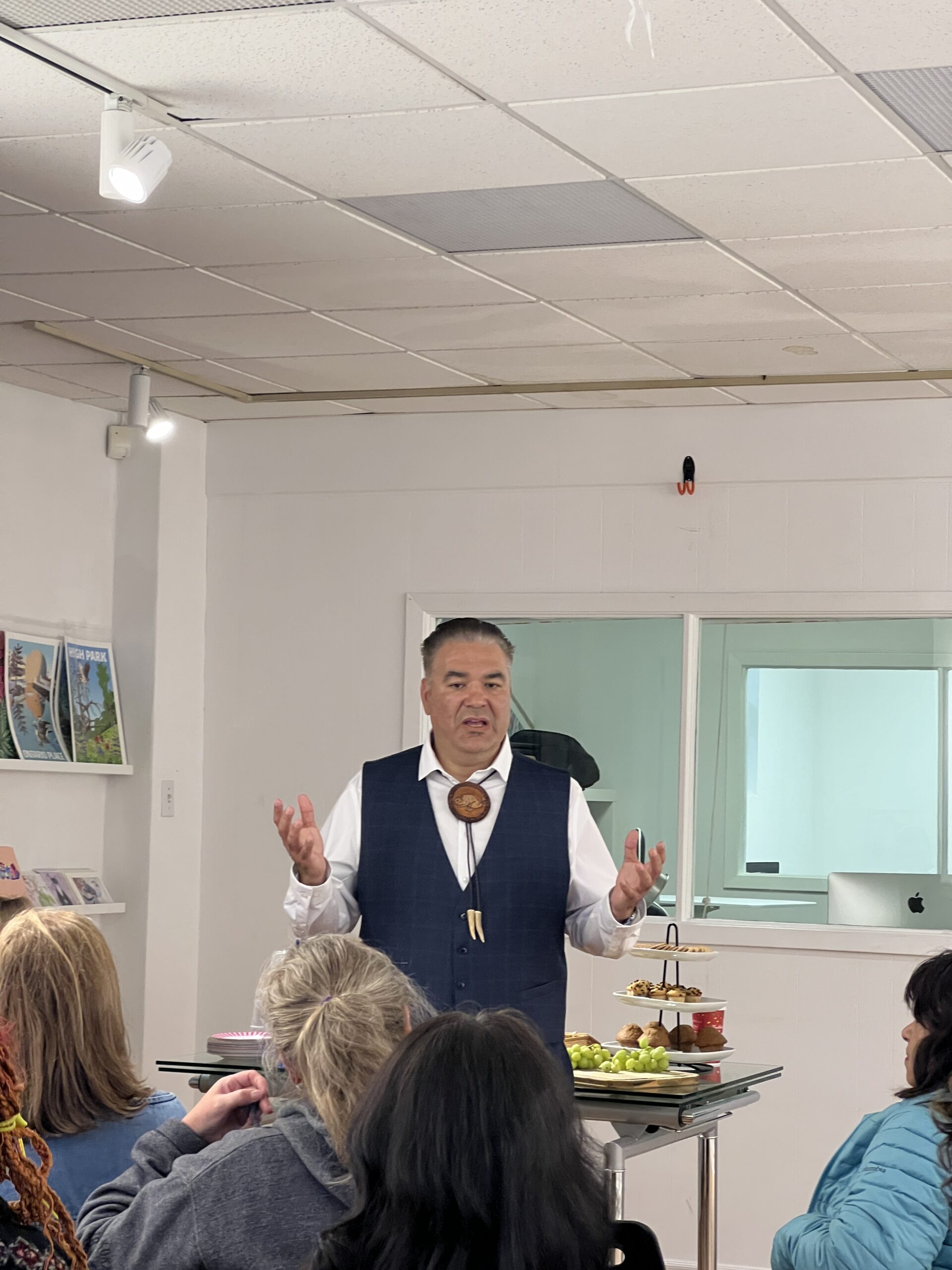 Image is about Artist Talk where person is standing named Dr. Rodney Haring explaining about his works